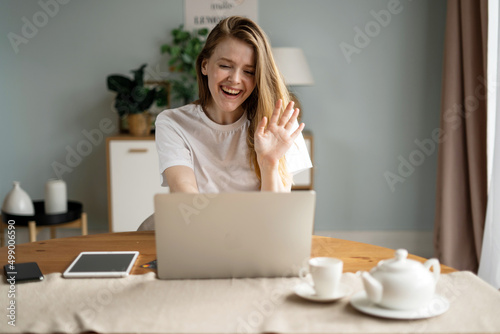 A woman online learning education at home, uses a laptop and an Internet site