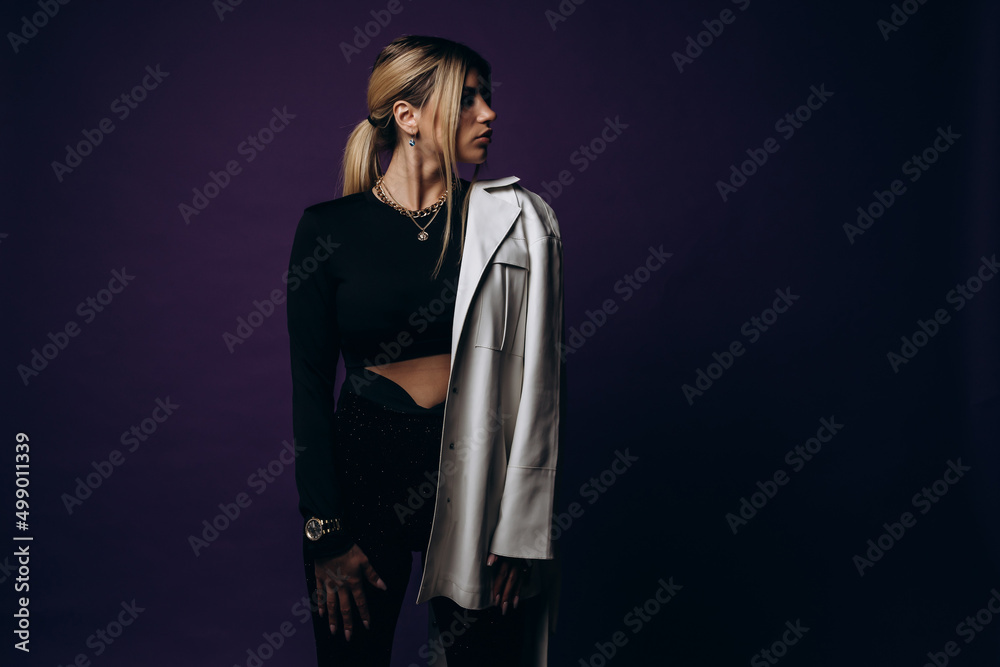Modern design. Young beautiful female fashion model in clothes on a purple background. Concept of design, fashion, vintage style Modern design. Young beautiful female fashion model in clothes on a purple background. Concept of design, fashion, vintage style