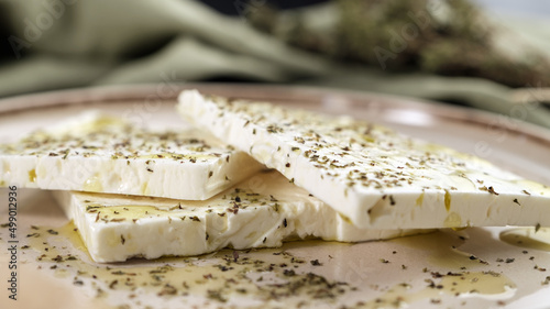 Fresh feta cheese with oregano and olive oil on plate