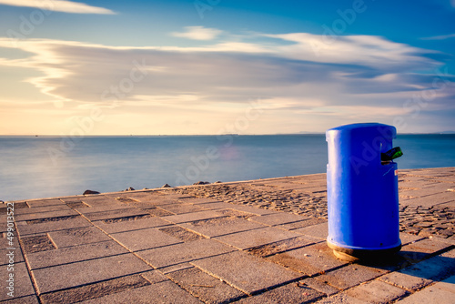 thrash can by the seashore.