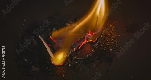 Closeup video of burning paper with HATE written on it