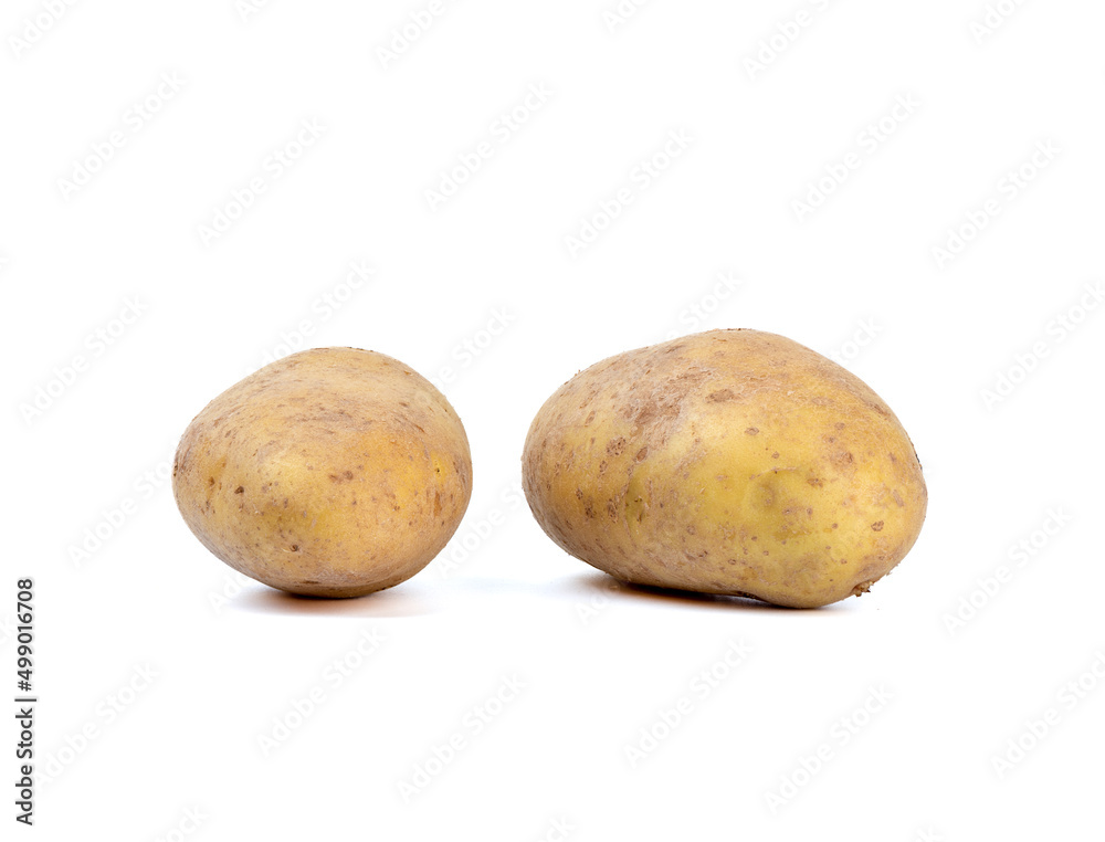 Tubers of unpeeled raw potatoes on a white background. Tubers of unpeeled raw potatoes on a white background.