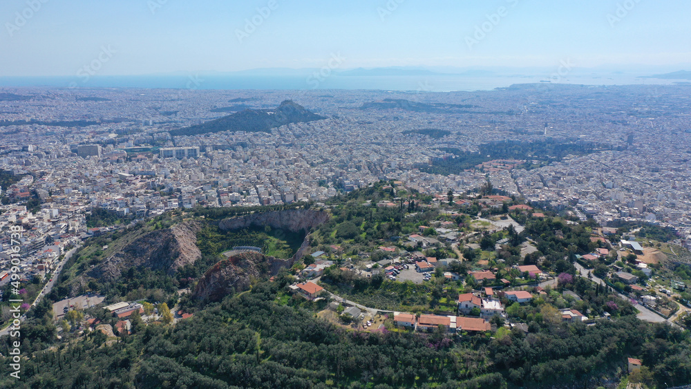 Aerial drone photo of famous hill of Tourkovounia with great view to Athens cityscape near alsos of Veikou and Galatsi area, Attica, Greece