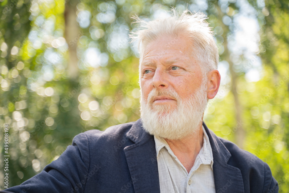 senior old man on the street of the city, with a beard and gray hair senior old man on the street of the city, with a beard and gray hair