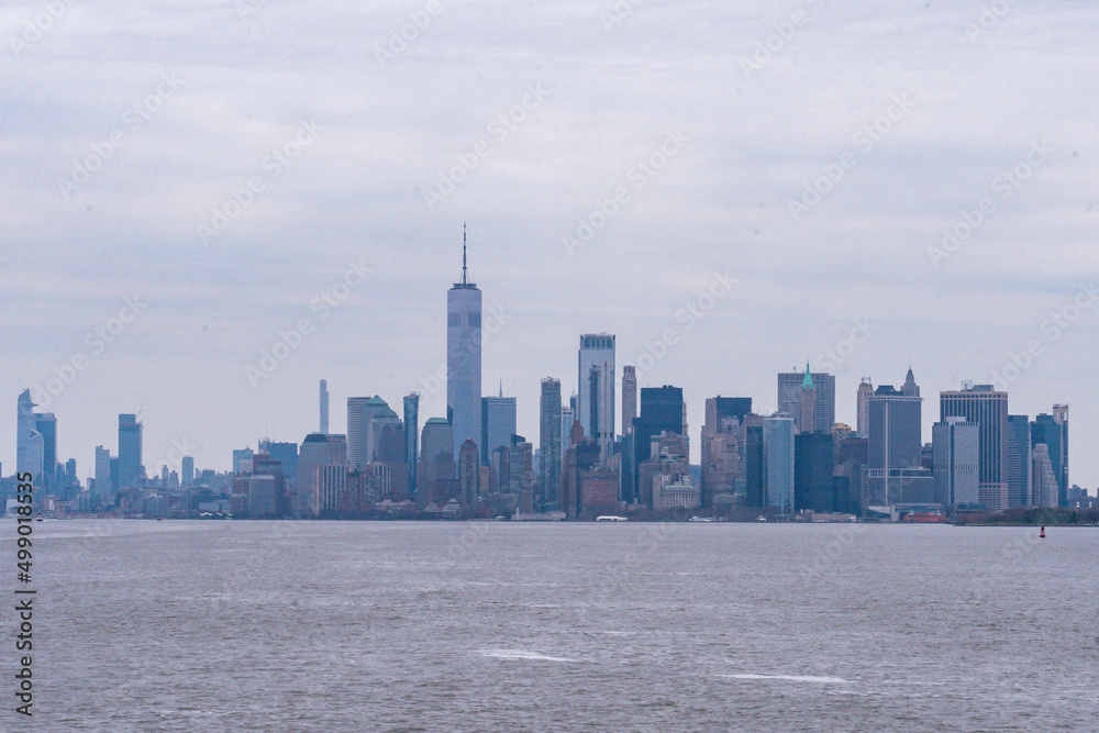 Naklejka premium The Freedom Tower and the buildings of lower Manhattan financial district downtown as seen from New York Harbor