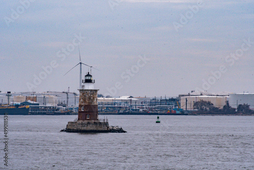 Tableau sur toile The Robbins Reef Lighthouse in New York Harbor between Jersey City, Manhattan an