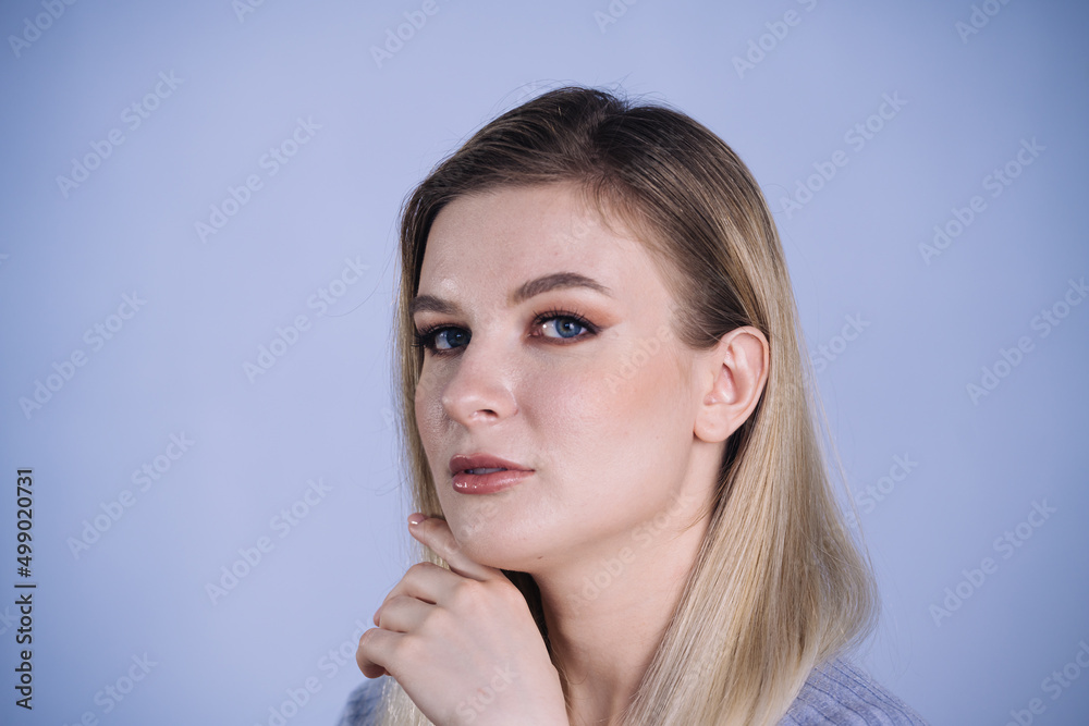 Beautiful young woman portrait, Cute female with long hair on blue background Beautiful young woman portrait, Cute female with long hair on blue background
