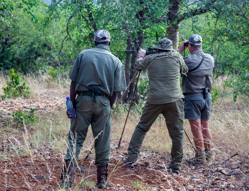 Shooter is hunter, huntsman or PH and tracker before shooting trophy on the hunt.