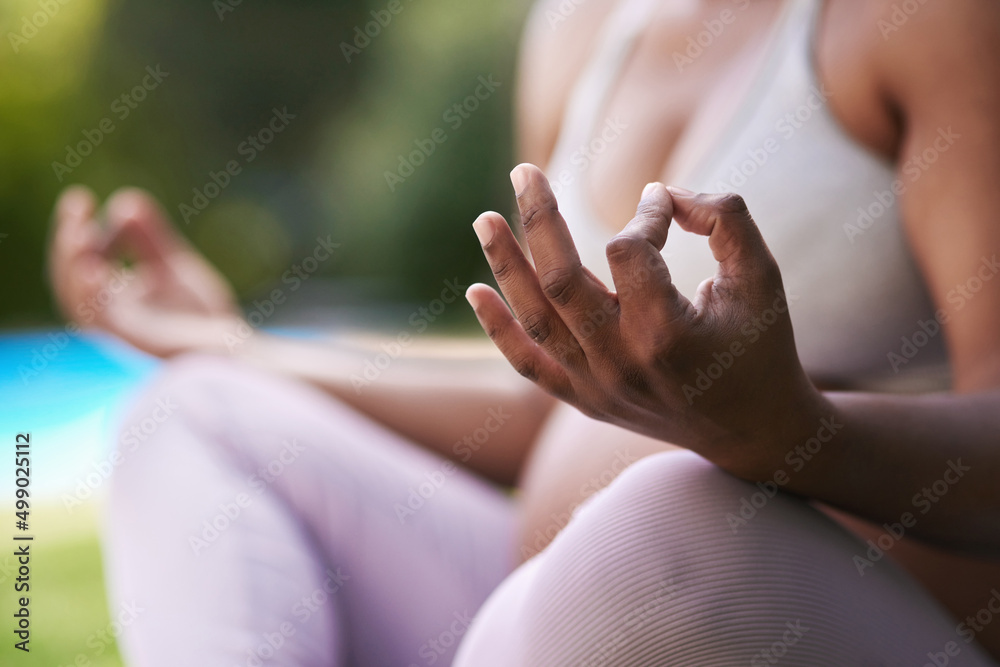 Yoga teaches you how to breathe deeply and consciously relax. Cropped shot of a pregnant woman meditating while sitting outside. Yoga teaches you how to breathe deeply and consciously relax. Cropped shot of a pregnant woman meditating while sitting outside.