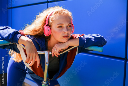 90s sporty style, modern trend.Girl old school clothes, natural look girl on the sports ground with a bike