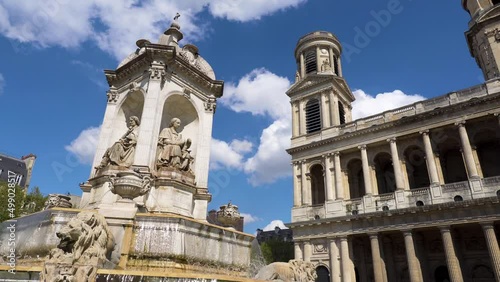 Fountain of Saint-Sulpice on a sunny day with the Church of Saint-Sulpice in the background - Paris, France