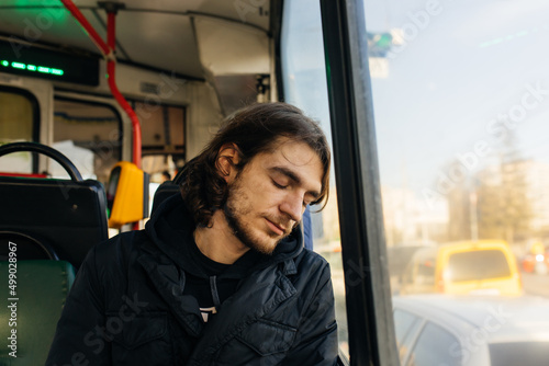 a sad young man rides a tram (bus). Daily life and commuting by public transport