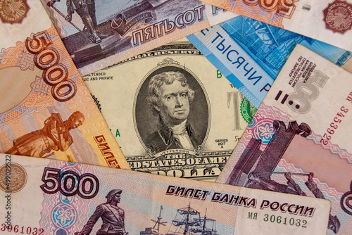 Two dollar banknote surrounded by ruble banknotes