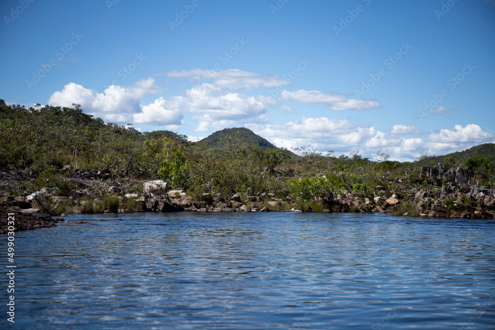 Landscape of Chapada dos Veadeiros National Park. View of Rio Preto, with mountains and forest in the background. Alto Paraíso de Goiás, Brazil. Clear skies on a sunny day.