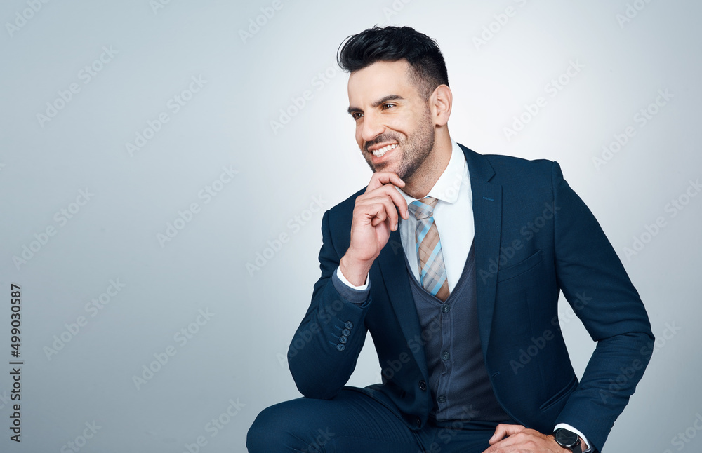 The path to greatness consists of having a strong purpose. Studio shot of a handsome young businessman looking thoughtful against a grey background. The path to greatness consists of having a strong purpose. Studio shot of a handsome young businessman looking thoughtful against a grey background.