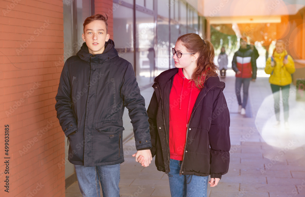 Young pretty couple of student boy and girl together outside happy smiling. Lifestyle people concept