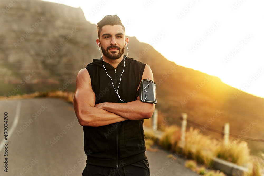 Working out has made him more confident. Shot of a young man exercising outdoors.