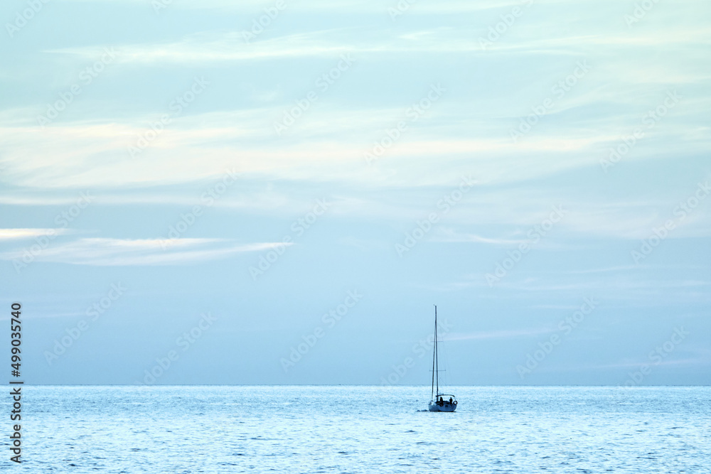 Fototapeta premium Sailing boat at sea. Sailboat management. Evening sea landscape.