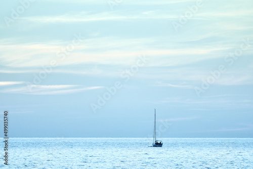 Sailing boat at sea. Sailboat management. Evening sea landscape.