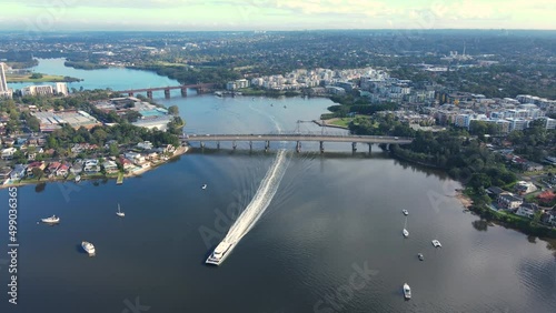 Aerial drone view of Ryde Bridge over Parramatta River between Rhodes and Meadowbank, Inner West suburbs of Sydney, with a large boat passing by   photo