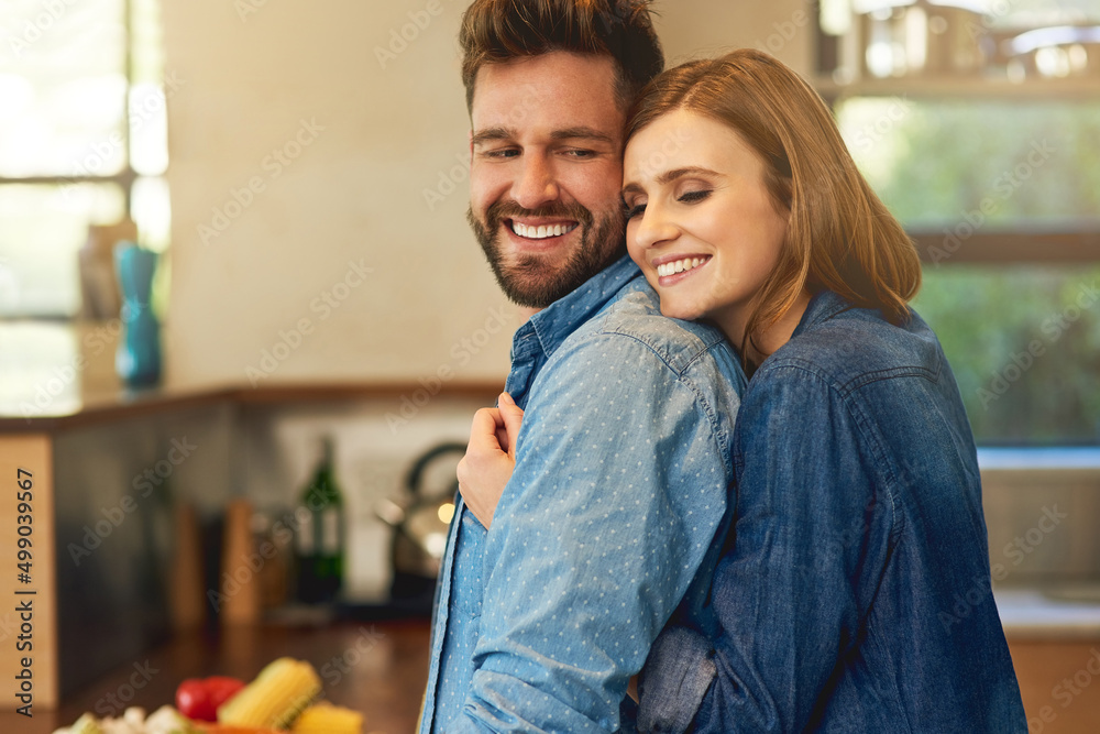If he cooks for you, hes a keeper. Shot of a happy young couple sharing an affectionate moment in the kitchen at home. If he cooks for you, hes a keeper. Shot of a happy young couple sharing an affectionate moment in the kitchen at home.