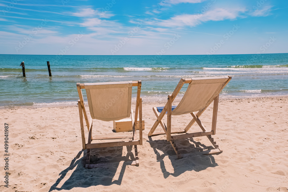 Two chairs on the beach near the sea