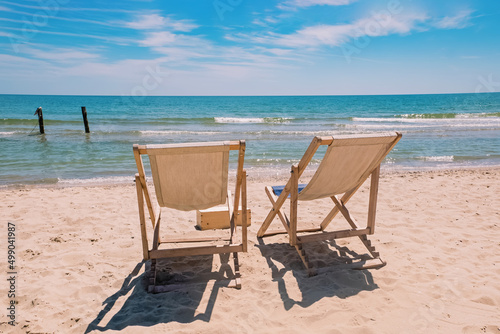 Two chairs on the beach near the sea © Diana Vyshniakova