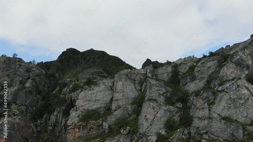 Flying up a mountain over a woman standing on top of it in slowmotion Flying up a mountain over a woman standing on top of it in slowmotion