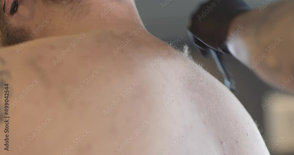 Shaving body hair the back of a man before a tattoo.
4K static shot. Shaving body hair the back of a man before a tattoo.
4K static shot.