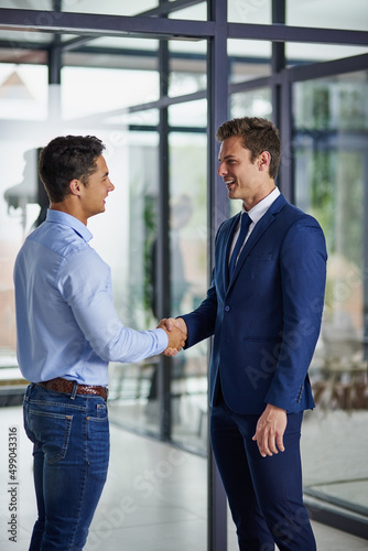 Partnering up to grow their dreams together. Shot of two businessmen shaking hands in an office. © K Seisa/peopleimages.com