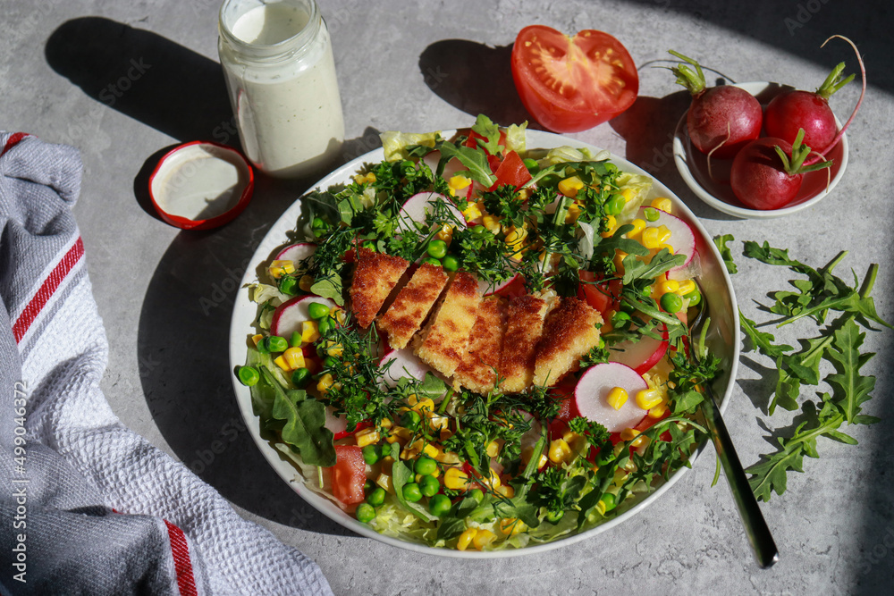 Southwest Chicken Salad on grey marble table with dressing Southwest Chicken Salad on grey marble table with dressing
