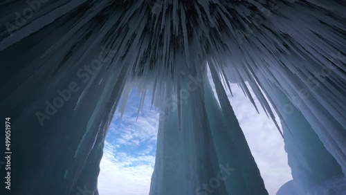 Big stalactites, sharp icicles, frozen cave and blue ice, iceberg of lake Baikal photo