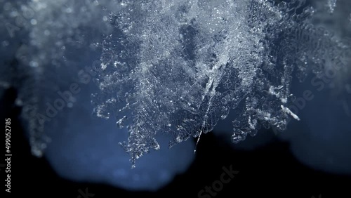 Beautiful crystal icicles, blue sharp ice snowflakes on stalactites inside cave  photo