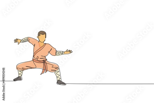 One continuous line drawing of young shaolin monk man practice kung fu style at temple ground . Traditional Chinese combative sport concept. Dynamic single line draw design vector graphic illustration