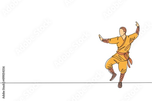 One single line drawing young energetic shaolin monk man exercise kung fu fighting at temple vector graphic illustration. Ancient Chinese martial art sport concept. Modern continuous line draw design