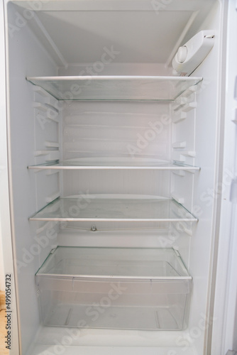 empty shelves of the open refrigerator. household appliances 