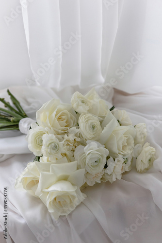 Stylish White wedding bouquet with ranunculus, roses, dianthus