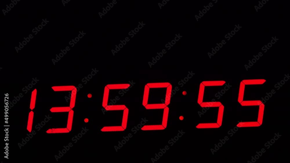 Digital timer on a black background. Light panel with red numbers