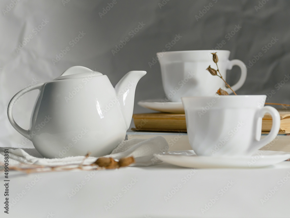 minimalistic white porcelain teapot and cups for tea drinking for two