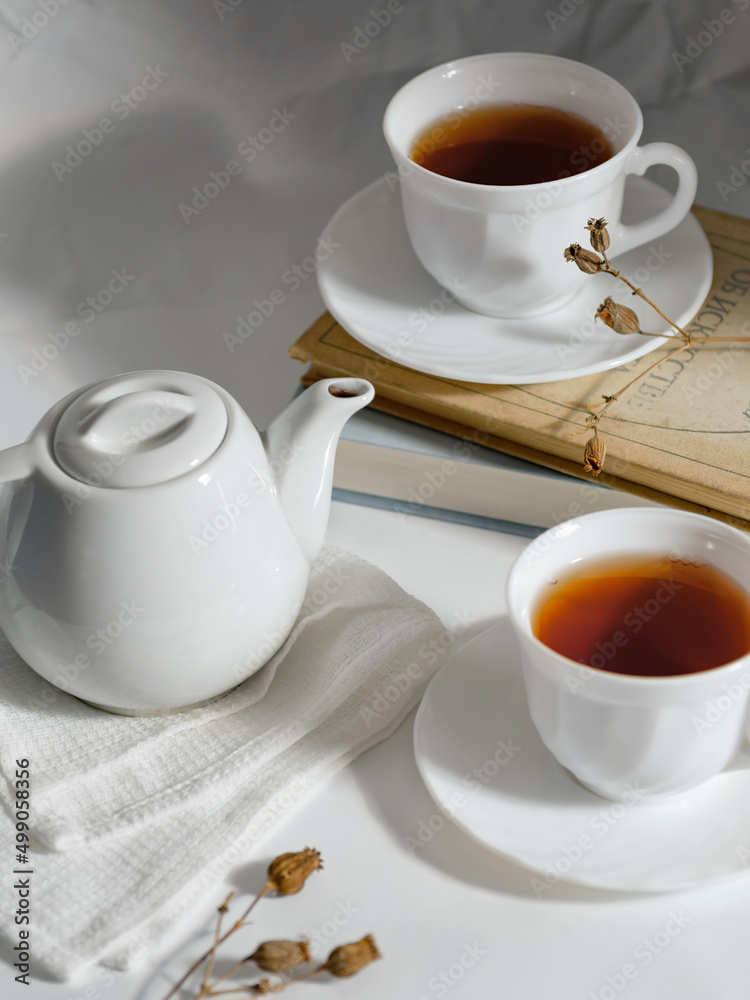 minimalistic white porcelain teapot and cups for tea drinking for two