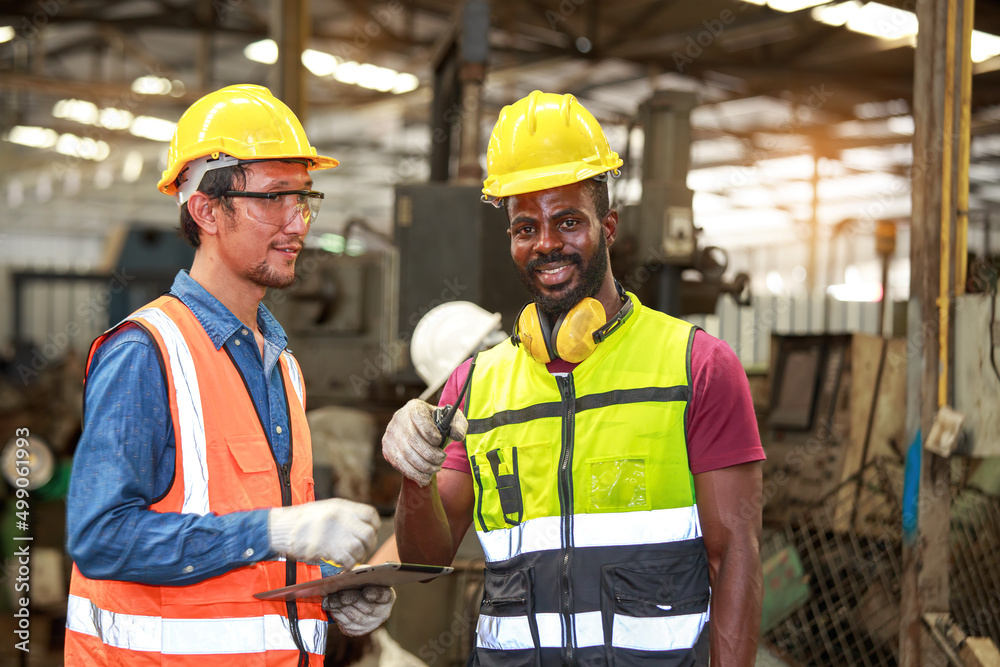 A team of Asian and African American male engineers congratulated. Availability of maintenance plans for industrial machines A team of Asian and African American male engineers congratulated. Availability of maintenance plans for industrial machines