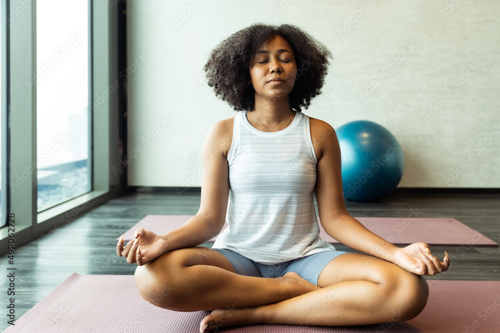 Asian and African American woman friend doing Yoga Pilates workout together.Close up of the hands of a woman doing yoga in the gym With a group. Asian and African American woman friend doing Yoga Pilates workout together.Close up of the hands of a woman doing yoga in the gym With a group.
