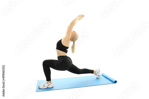 Sporty woman doing exercise on fitness mat, isolated on white background