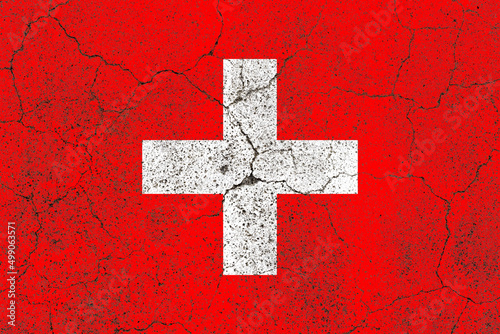 Switzerland flag on a cracked old concrete wall surface