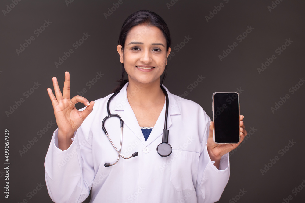 young doctor woman showing blank screen of smartphone young doctor woman showing blank screen of smartphone