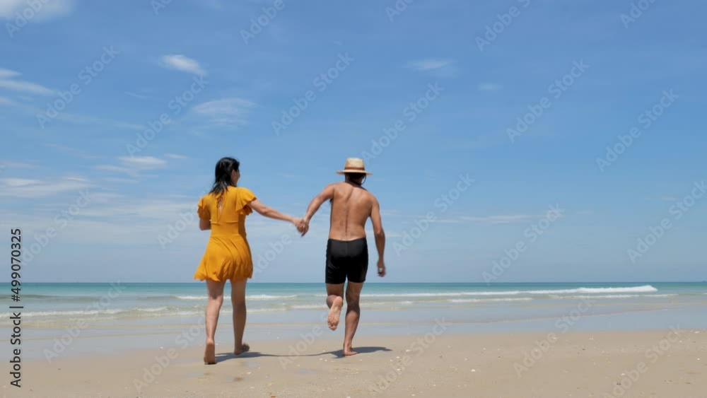 Happy couple in love, playing on the beach at sunny, running and splashing in the waves, travel vacation lifestyle
Happy couple in love, playing on the beach at sunny, running and splashing in the waves, travel vacation lifestyle
