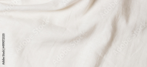 White crumpled linen fabric texture background. Natural linen organic eco textiles canvas background. Top view photo