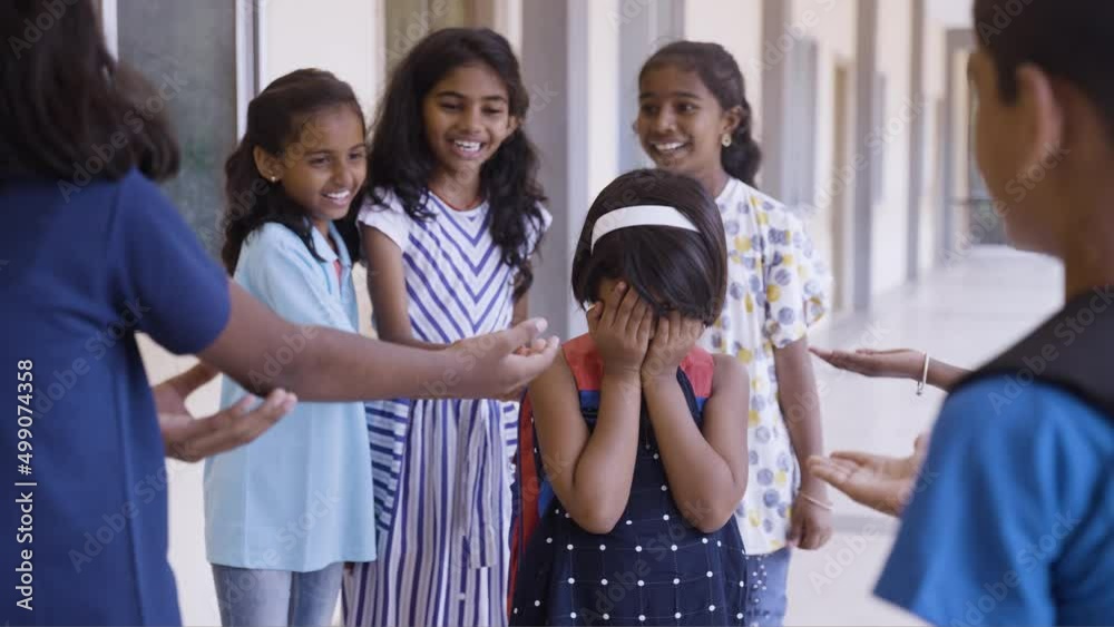 Group of children buylling girl kid by surrounding at school corridor ...