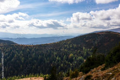 Panoramic view on Mur valley from Seckauer Zinken in the Lower Tauern in Styria, Austria, Europe. Forest on a hill on cloudy autumn day in Seckau Alps. Hiking trail on dry and bare terrain. Soft hills