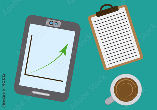 Espacio de trabajo con tablet, bloc de notas y taza. 